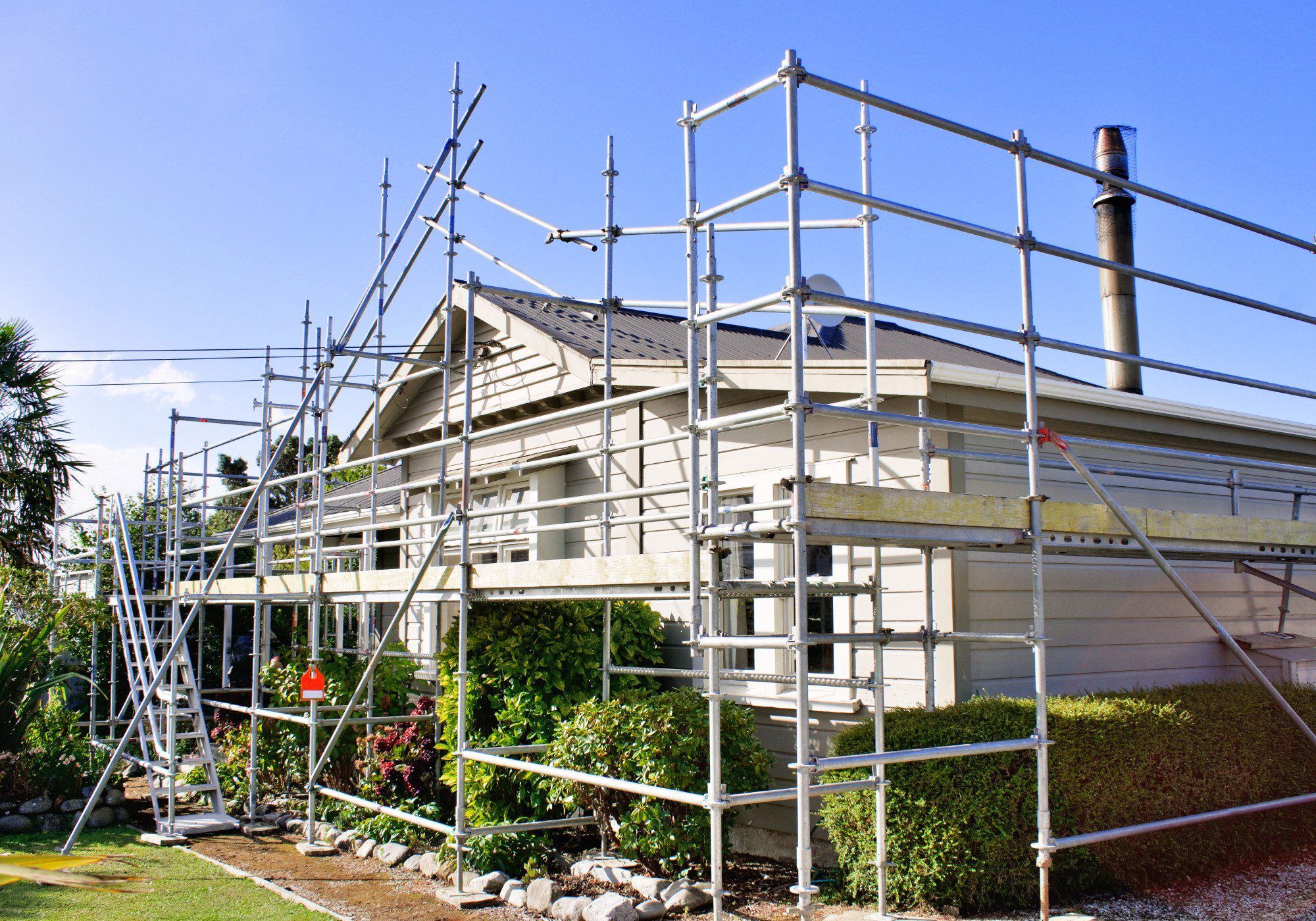 House under construction with metal scaffolding.